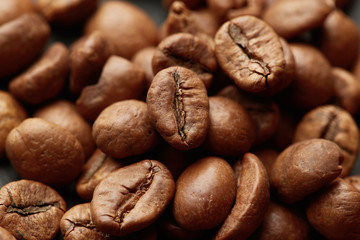 Roasted coffee beans close up. Espresso dark, aroma, black caffeine drink