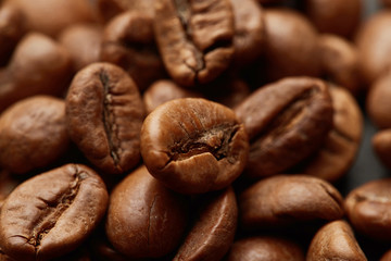 Roasted coffee beans close up. Espresso dark, aroma, black caffeine drink