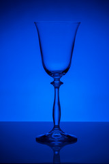 empty wine glass on blue background