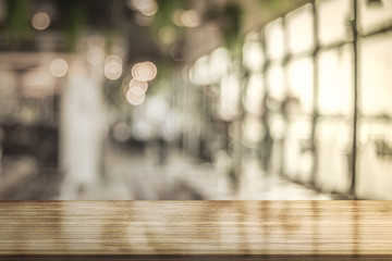 Wooden top table with bokeh light effect and blur beverage bar on background