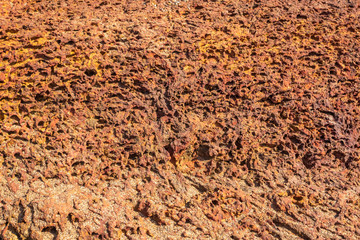 Stone texture in red brown colors. Porous limestone. 