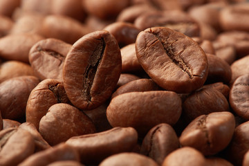 Roasted coffee beans close up. Espresso dark, aroma, black caffeine drink