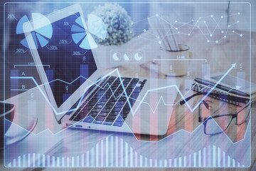 Financial chart drawing and table with computer on background. Double exposure. Concept of international markets.