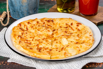 Caucasian dish khachapuri with egg served on a white plate