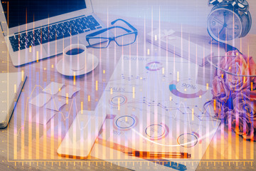 Financial graph colorful drawing and table with computer on background. Double exposure. Concept of international markets.