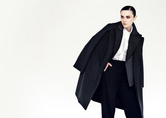 studio fashion portrait of yong pretty woman in black coat - 321422217