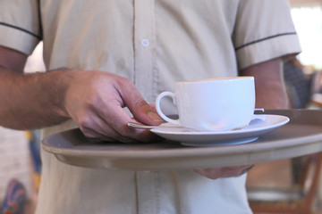 man serving coffee at cafe in local city 