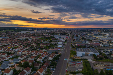 Aerial townscape view of Dijon city under orange sunset sky 