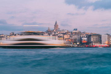 Naklejka premium Istanbul, Turkey - Jan 15, 2020: Galata Tower with Ferry Boat in Golden Horn , Istanbul, Turkey,