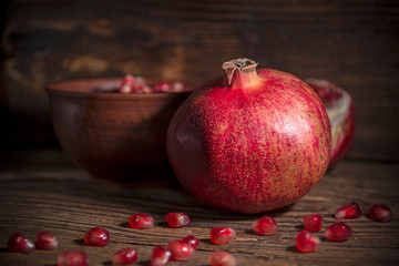 Juicy red pomegranates on wooden background