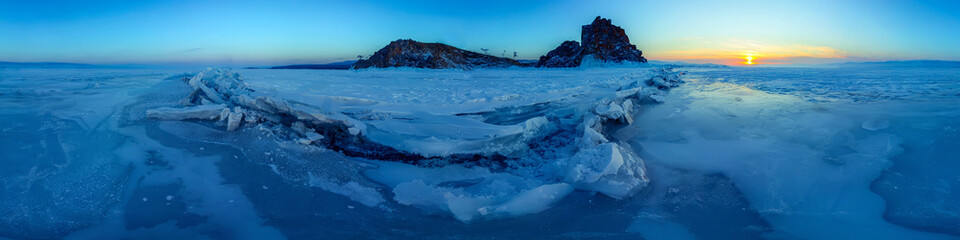 Big cracks in the ice of Lake Baikal at the Shaman Rock on Olkhon Island. .Cylindrical panorama 360