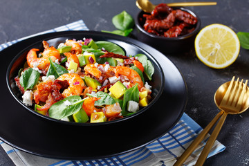 shrimp avocado spinach salad in a bowl