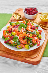 tasty shrimp avocado spinach salad on a plate