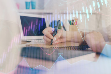 Financial graph displayed on woman's hand taking notes background. Concept of research. Double exposure