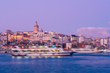 Istanbul, Turkey - Jan 15, 2020: Galata Tower with Ferry Boat in Golden Horn , Istanbul, Turkey,