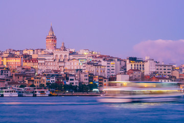 Obraz premium Istanbul, Turkey - Jan 15, 2020: Galata Tower with Ferry Boat in Golden Horn , Istanbul, Turkey,