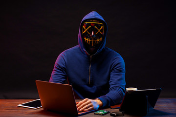 hacker committing a crime with the aid of computers and information technology infrastructure, use...