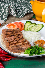 Grilled beef steak served with fresh vegetables