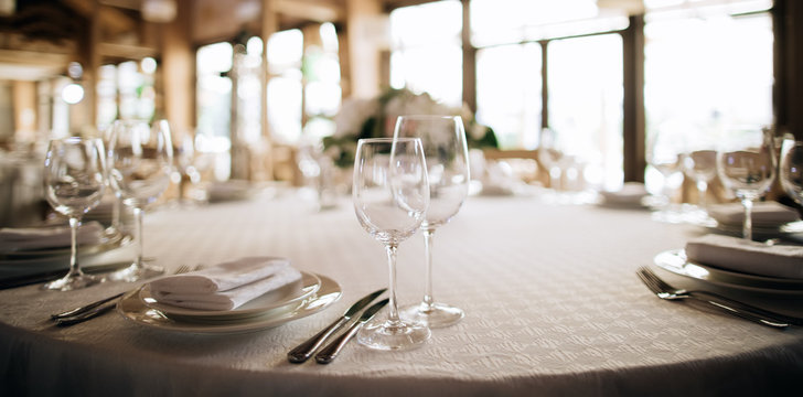 white table set for dinner with wine glasses in restaurant