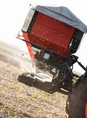 Tractor spreading artificial fertilizers