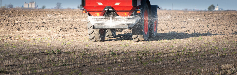 Tractor spreading artificial fertilizers