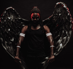 muscular african man with dreadlocks became dark angel and now live in heaven, unusual photoshot of...