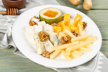 Cheese plate with different types of cheese on a white plate