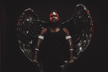 portrait of reckless dark angel with strong muscles, having athletic body, african man in the flesh of dark angel illustrate falling from heaven, angel wants to give people the right decision