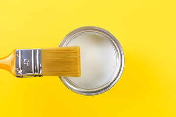 White Paint Can with Brush Top View On Yellow Background. - Image