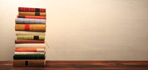 Old books on a wooden shelf.