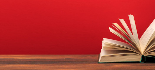 Open book  on red background. text place .