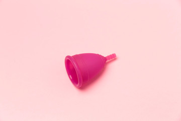 Menstrual Cup on pink background. Copy space. Woman hygiene protection. Symbol.