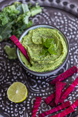 Delicious green healthy dip with beetroot sticks