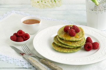vegetarian spinach pancakes with raspberries and honey.