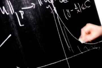 Teacher writing a mathematical equation on a  screen