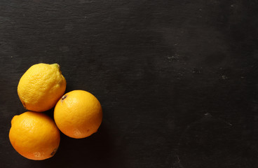 Photography of three lemons on a slate for restaurant menus