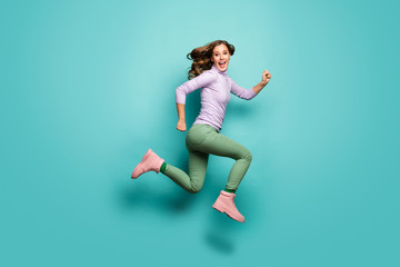 Fototapeta na wymiar Full body profile photo of crazy beautiful lady jump high up speed rushing black friday addicted shopper wear purple jumper green pants footwear isolated teal pastel color background