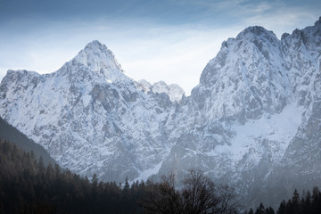 beautiful snowy winter mountain range landscape in julian alps, slovenia