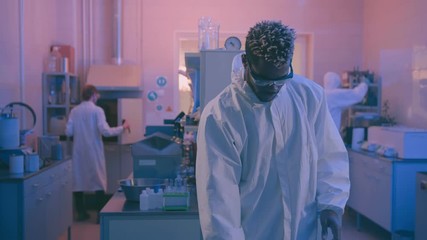 Young afro-american doctor analyzing macro scan of bacteria of germ - Powered by Adobe
