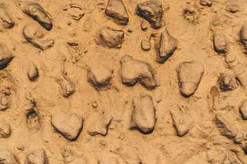 Rough texture wall background. Old orange wall with stones