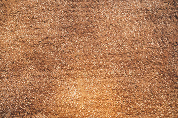 Rough texture wall background. Brown surface with fine white crumbs
