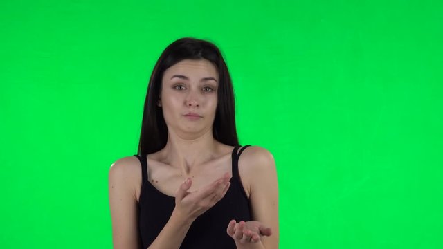 Young girl negatively waving her head expressing she is innocent. Green screen