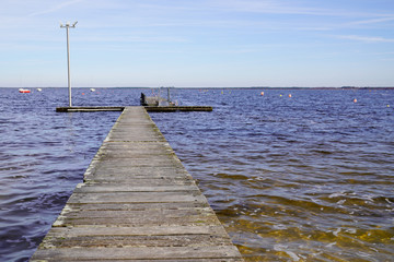 pier wood boat dock wooden pontoon on lake of Maubuisson Carcans France