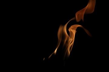 Hot orange tongues of flames in dark background