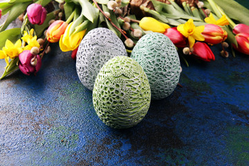 Obraz na płótnie Canvas Easter eggs and tulips and daffodils on rustic background. Springtime decoration
