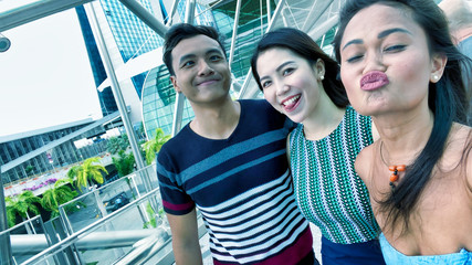 Happy young asian friends enjoying city view outdoor