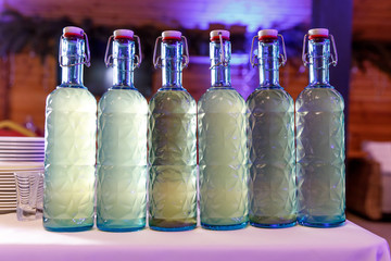 Row of homemade alcohol bottles.