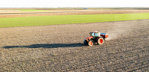 Tractor spreading artificial fertilizers