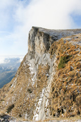 Sheer cliffs. Blue sky. View from the top.
