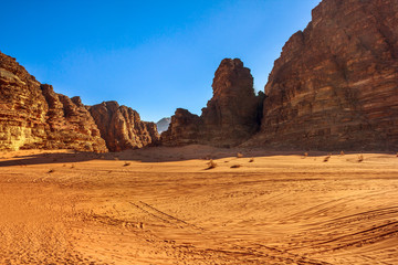 Wadi Rum Desert and Valley of the Moon at sunset in southern Jordan. Popular tourist destination for spectacular sandstone and granite rock. Aerial view landscape.
